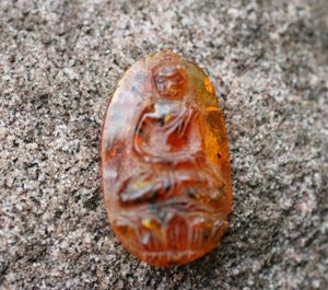 Amber with carved Buddha